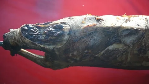 Whole lamb roasting on a spit over charcoal barbecue 動画素材 91868148