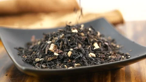 Whole leaf black tea falling into a samp... | Stock Video | Pond5
