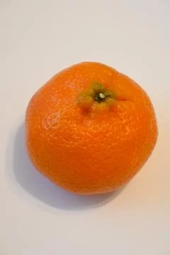 Whole mandarin on a light background Stock Photos