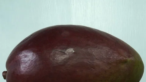 Whole mango fruit spinning Stock Footage 146680543
