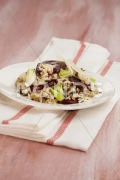 Whole-meal risotto with beetroot and leek Stock Photos