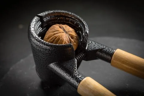 Whole nuts and nutcracker. Stock Photos