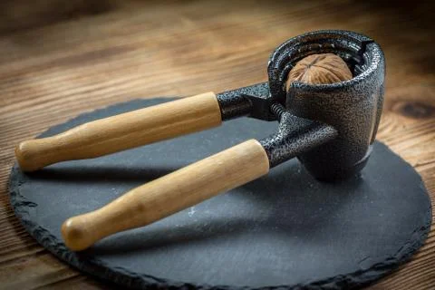 Whole nuts and nutcracker. Stock Photos