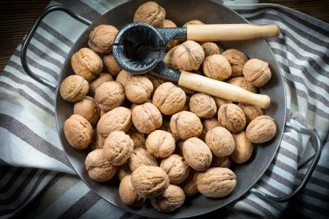 Whole nuts and nutcracker. Stock Photos