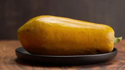 A whole papaya on a plate Stock Footage 328896545