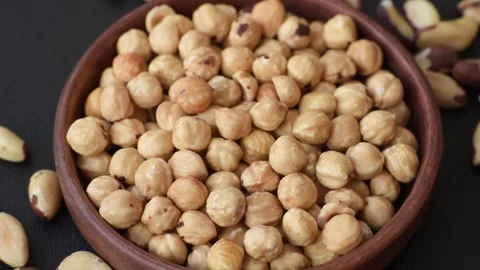 Whole peeled hazelnuts, roasted or raw, as an ingredient for healthy food. Hazel Stock Footage 329388385