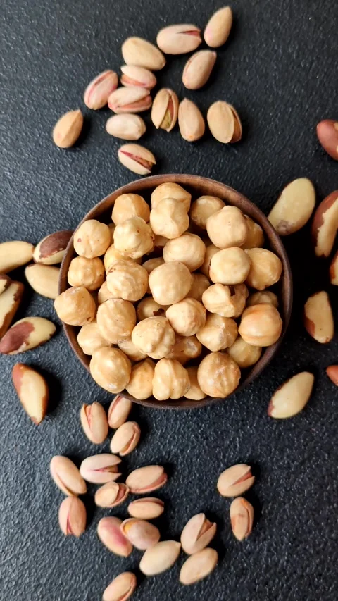 Whole peeled hazelnuts, roasted or raw, as an ingredient for healthy food. Hazel Video stock 329388784