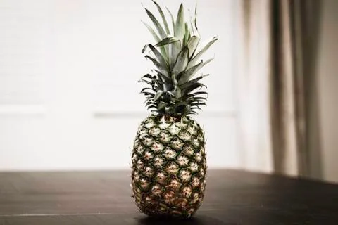 Whole Pineapple sitting on table  Stock Photos