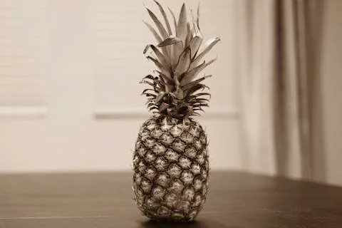 Whole Pineapple sitting on table  Stock Photos