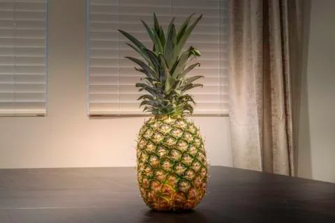 Whole Pineapple sitting on table  Stock Photos