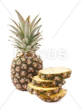Whole pineapple with stack of slices isolated over white background Stock Photos