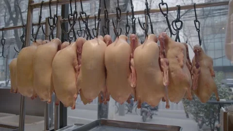 Whole Raw Ducks Hanging in Restaurant Kitchen Window in Beijing, China Stock Footage 345854394