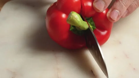 Whole red bell pepper rotated and cored to remove the stem Stock Footage 344177261