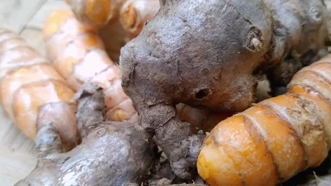 Whole Red Ginger and Raw Turmeric Roots Arranged on a Woven Bamboo Mat Stock Footage 340538093