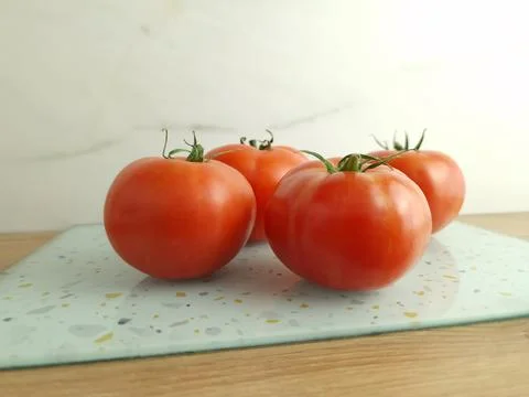 Whole red tomatoes on table Stock Photos