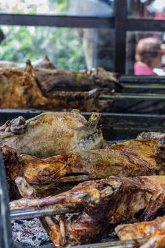 Whole Roasted Lamb On Spit Over Hot Coals At Traditional Outdoor Barbecue Roa Stock Photos
