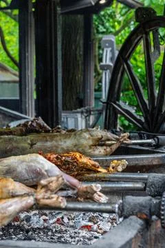 Whole Roasted Lamb On Spit Over Hot Coals At Traditional Outdoor Barbecue Roa Stock Photos