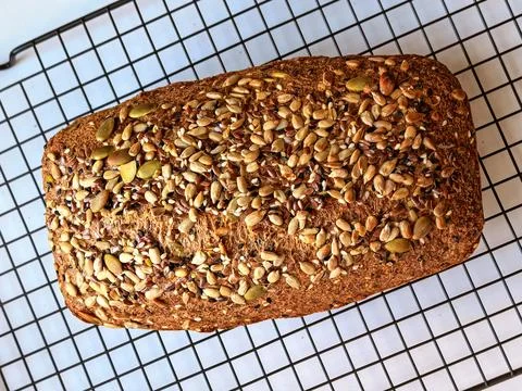 Whole Seeded Keto Bread Cooling On Wire Rack Stockfoto's