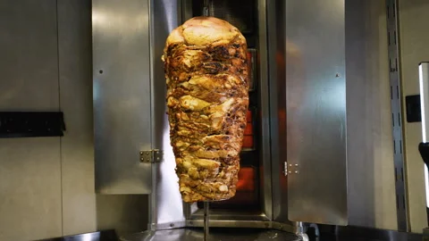 Whole Shawarma Stack Roasting on Vertical Grill Stock Footage 311484120