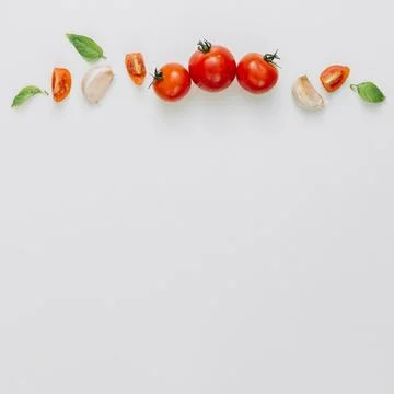 Whole slice cherry tomatoes garlic clove basil white background Stock Photos