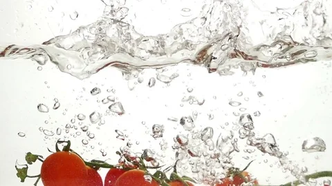 Whole Tomatoes Falling Through Water. Stock Footage 72450044