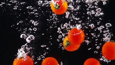 Whole Tomatoes Falling Through Water. Stock Footage 72965850