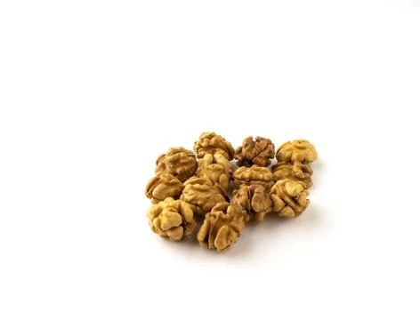 Whole walnut kernels on a white background. Stock Photos