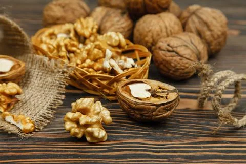 Whole walnuts and kernels on the table Stock Photos
