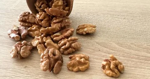 Whole walnuts and split on table. kernels of walnuts are dried and ready to eat Stockfoto's