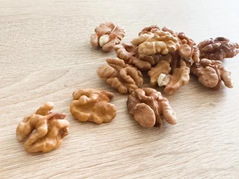 Whole walnuts and split on table. kernels of walnuts are dried and ready to eat 写真素材