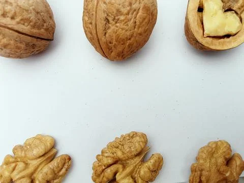 Whole walnuts and walnut kernels on white background Stock Photos