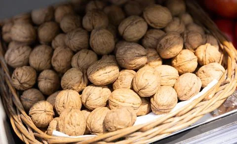 Whole walnuts with brown nutshells on retail market closeup Stock Photos