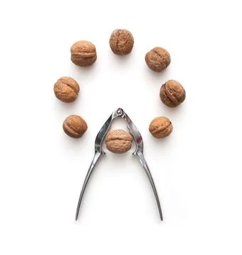 Whole walnuts circle shape and tongs Stock Photos