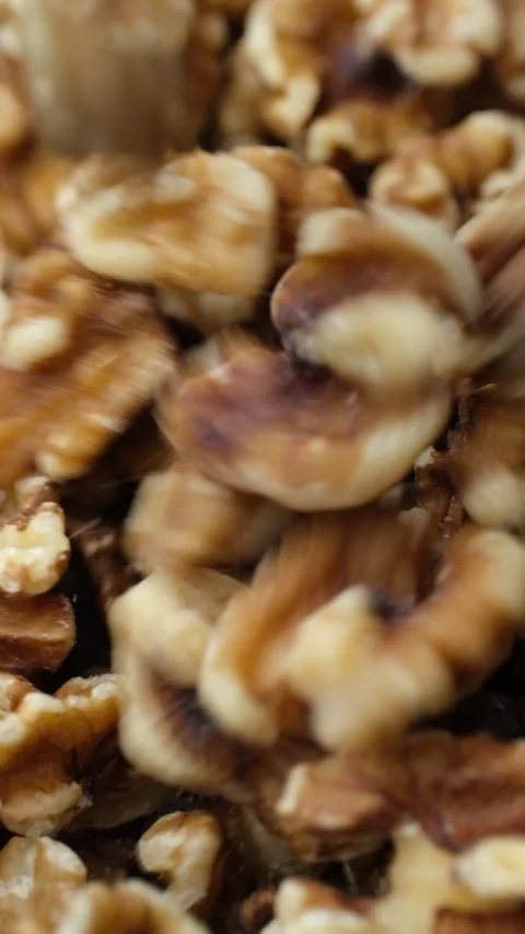 Whole walnuts falling down in bowl, top view Stock Footage 282444264