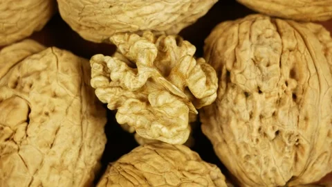 Whole walnuts kernel on nuts in shell rotating slowly Stock Footage 181598130