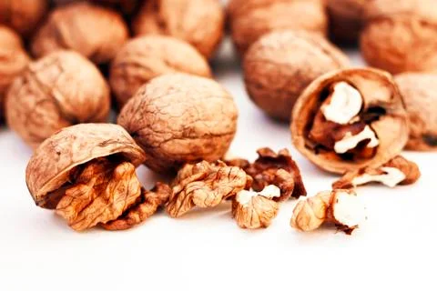 Whole walnuts kernels on white background. Stock Photos
