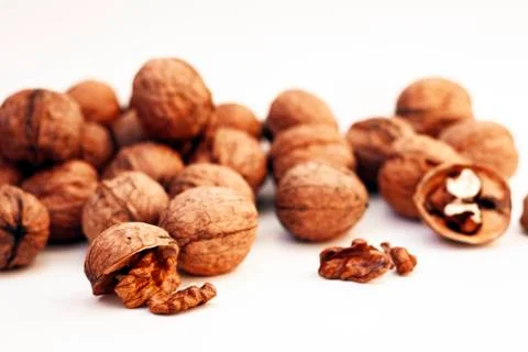 Whole walnuts kernels on white background. Stock Photos