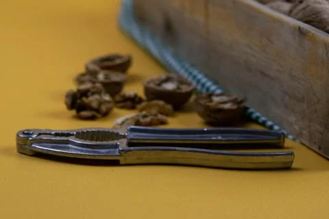 Whole walnuts in shells in a box, walnuts kernels. next to the box is a nut c Stock Photos