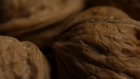 Whole walnuts in shells rotating in a macro view 動画素材 327948868