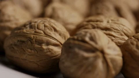 Whole walnuts in shells rotating slowly in macro Stock Footage 328143267