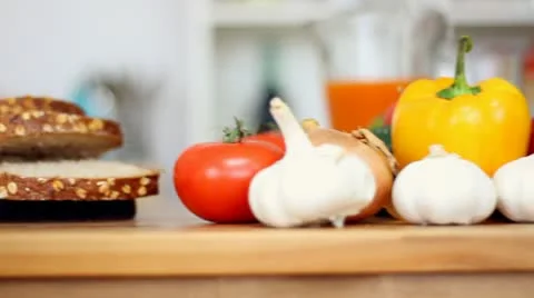Whole wheat bread and vegetables on the table, steadicam shot HD Video stock 8990656