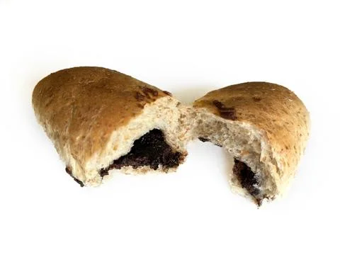 Whole wheat bread bun broken in half with chocolate filling Stock Photos