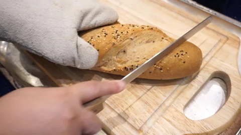 Whole Wheat Bread cutting on wood board Stock Footage 91385035