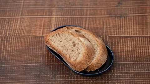 Whole wheat bread on a plate Stock Footage 183496239