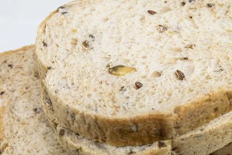 Whole wheat bread slice on white background Stock Photos