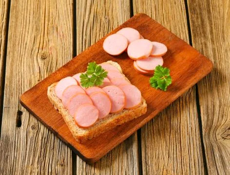 Whole wheat bread with slices of lean sausage Stock Photos