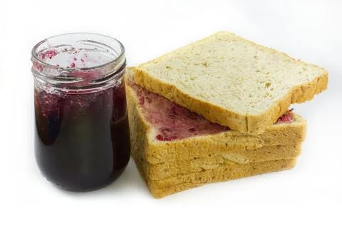 Whole wheat bread stack with grape jam on isolated white background. Stock Photos