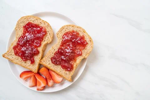 Whole wheat bread with strawberry jam and fresh strawberry Stock Photos