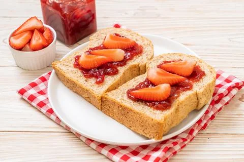 Whole wheat bread with strawberry jam and fresh strawberry Stock Photos