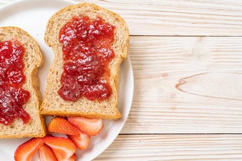Whole wheat bread with strawberry jam and fresh strawberry Stock Photos